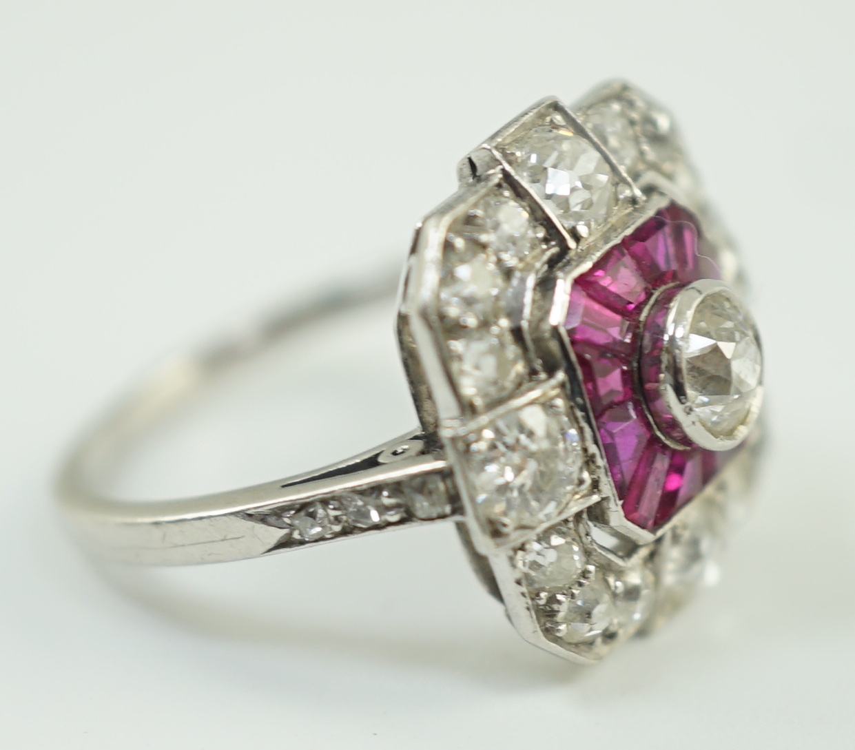 A 1920's/1930's platinum, ruby and diamond cluster set dress ring